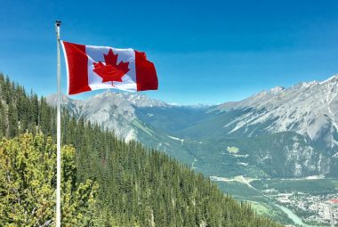 Canada flag over mountains