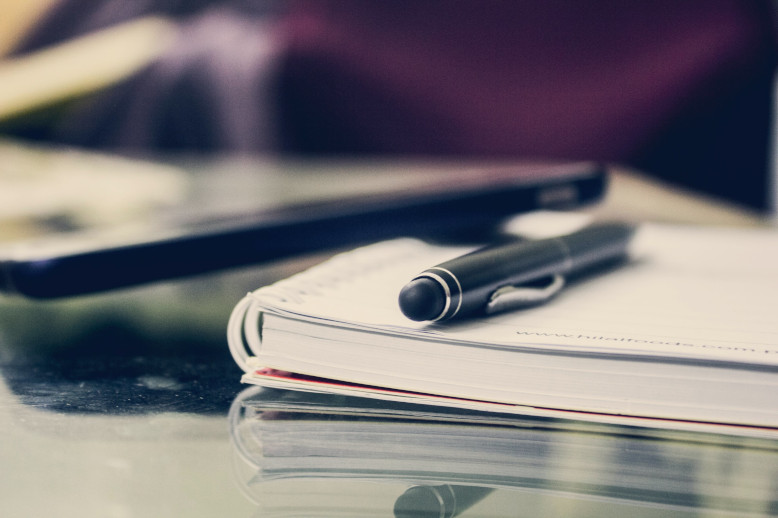 pen on notebook on notary public desk