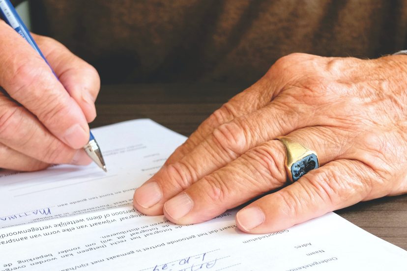 older man about to sign paperwork to be notarized