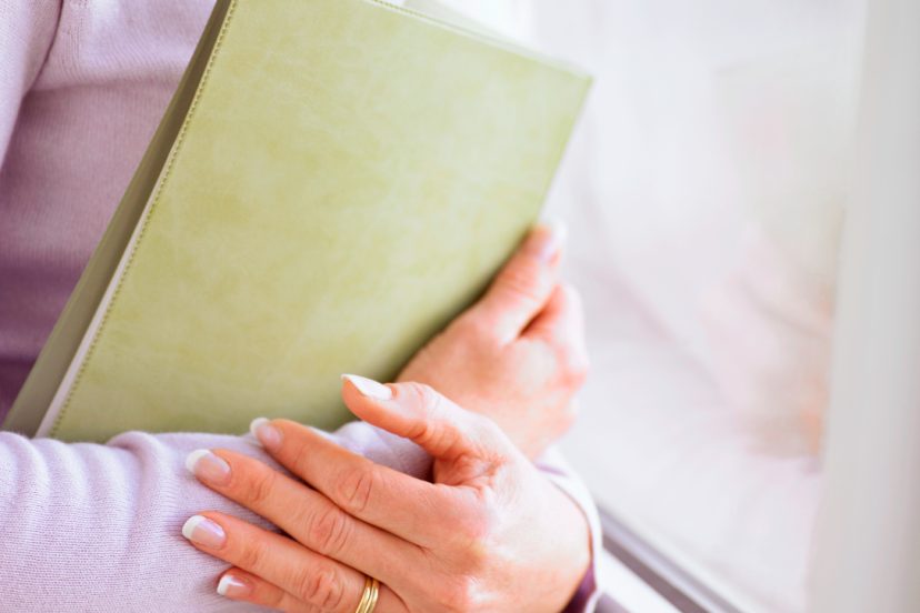 lady holding green folio