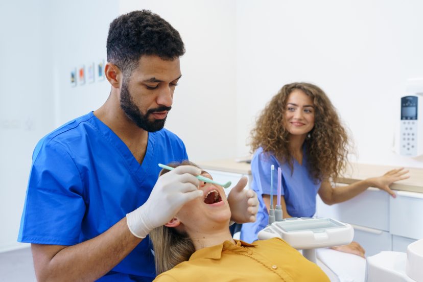 Dental examination of young woman at dental clinic.